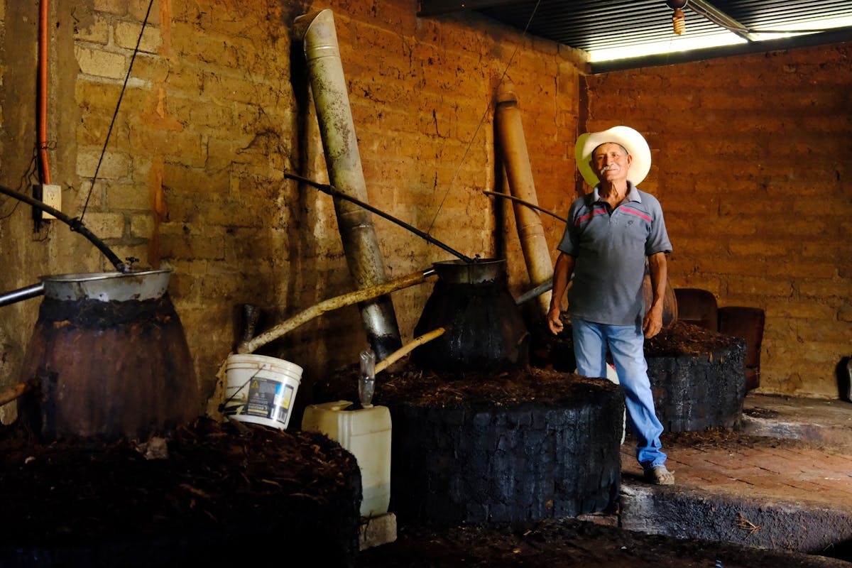 Worker at a traditional mezcal distillery in Oaxaca